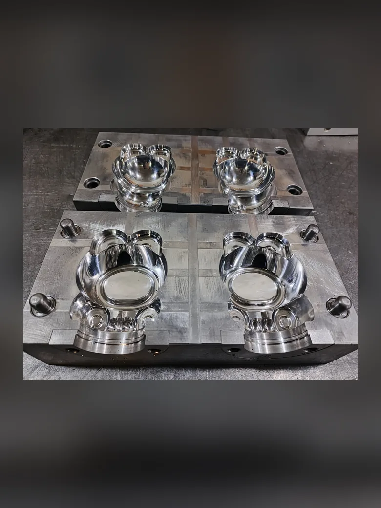A polished injection stretch blow mould showing its cavity detail
